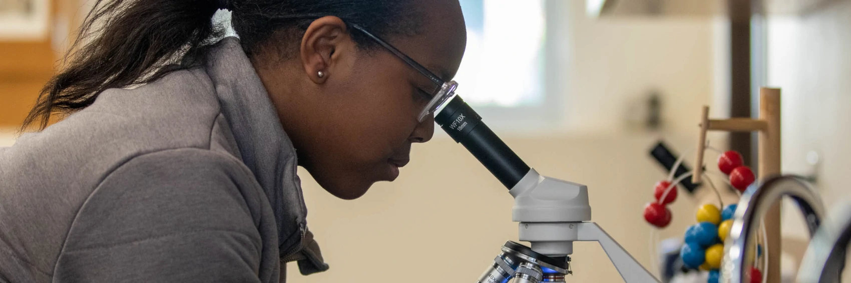 Student looks through a microscope